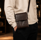 Men's premium PU leather crossbody bag in coffee brown on wooden table